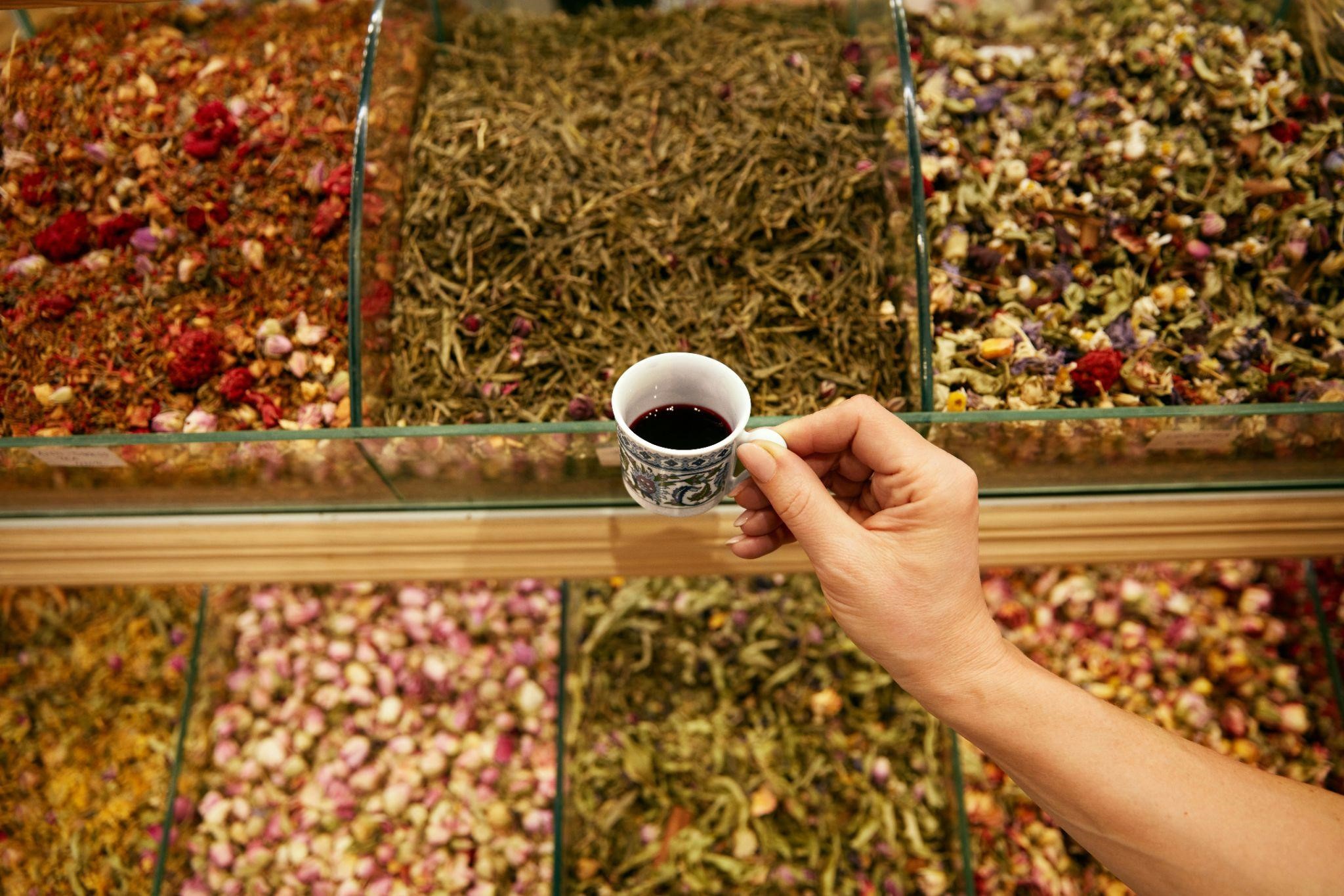 Chinese herbal tea in hand at herb shop